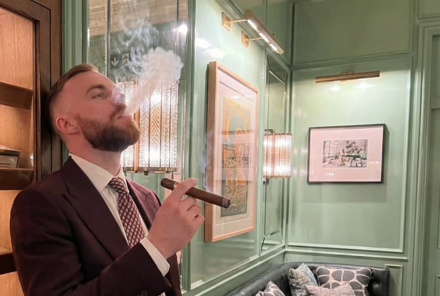 Ethan in a suit with a cigar