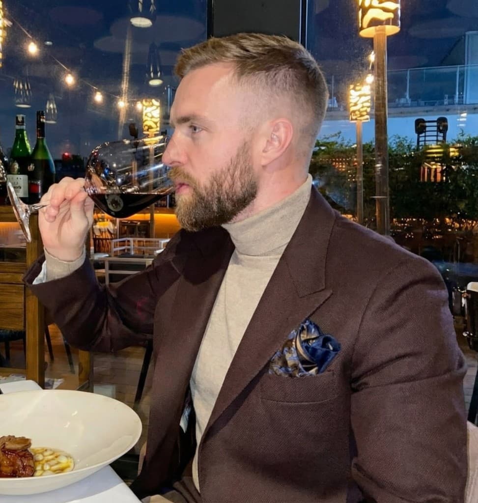 Ethan enjoying red wine at a restaurant